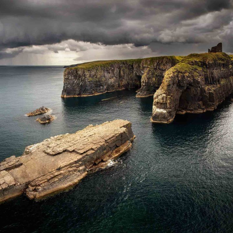 Wick Castle on the cliffs overlooking the sea