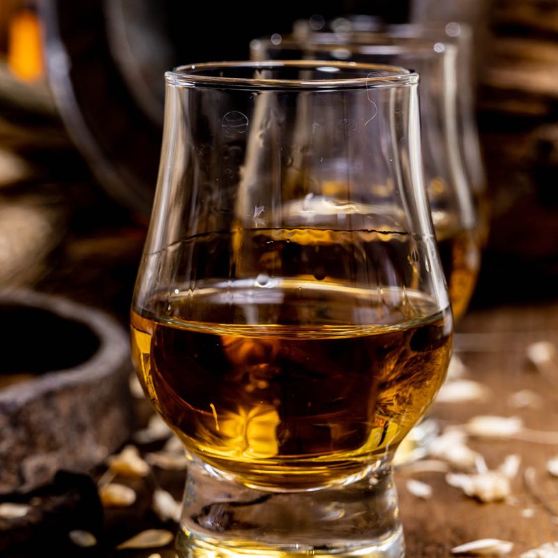 Two drams of whisky by a barrel and some barley