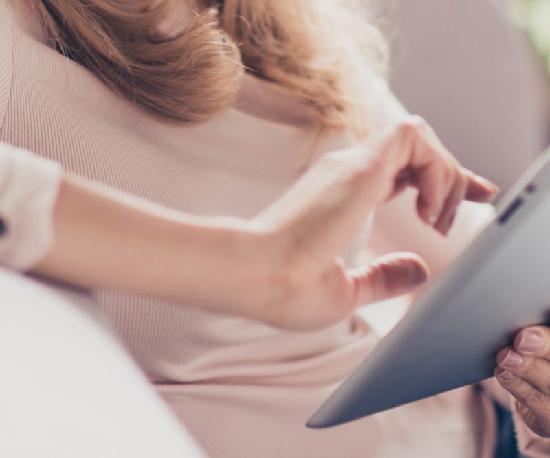 Woman using a tablet to book online