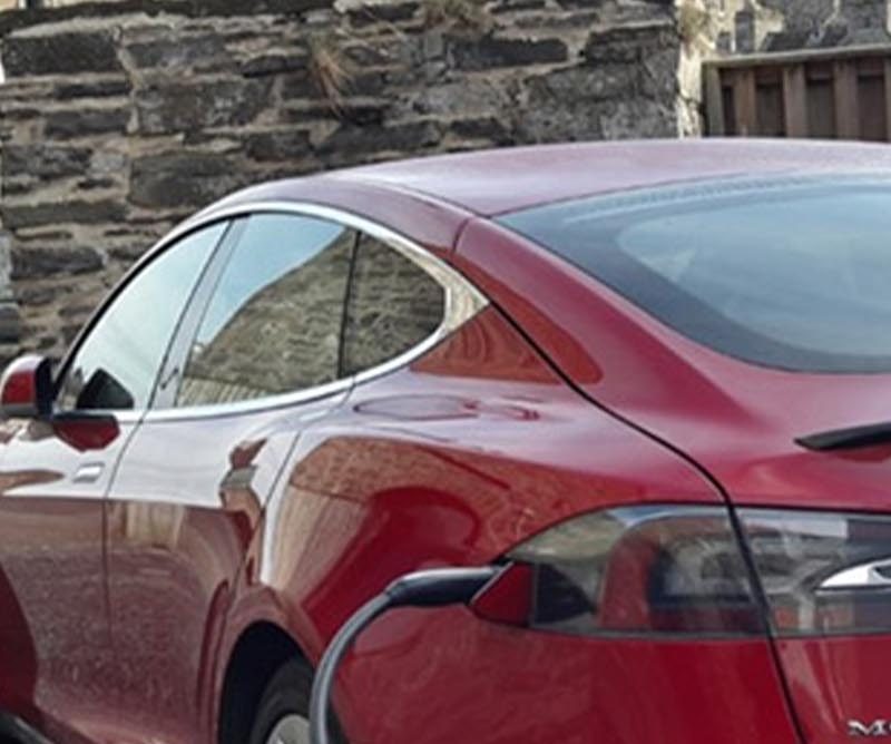 An electric Tesla car charing at Mackays Hotel in Wick
