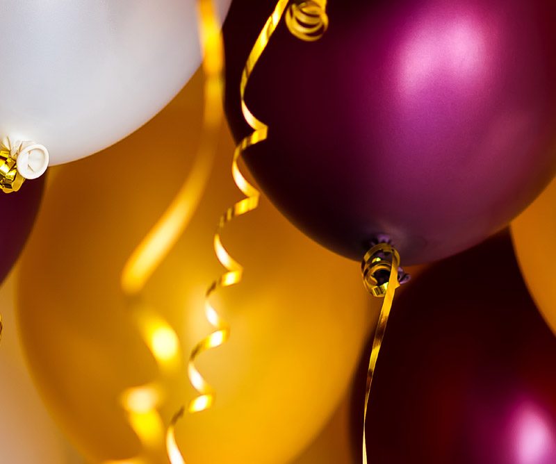 Purple, white and gold balloons at a party venue