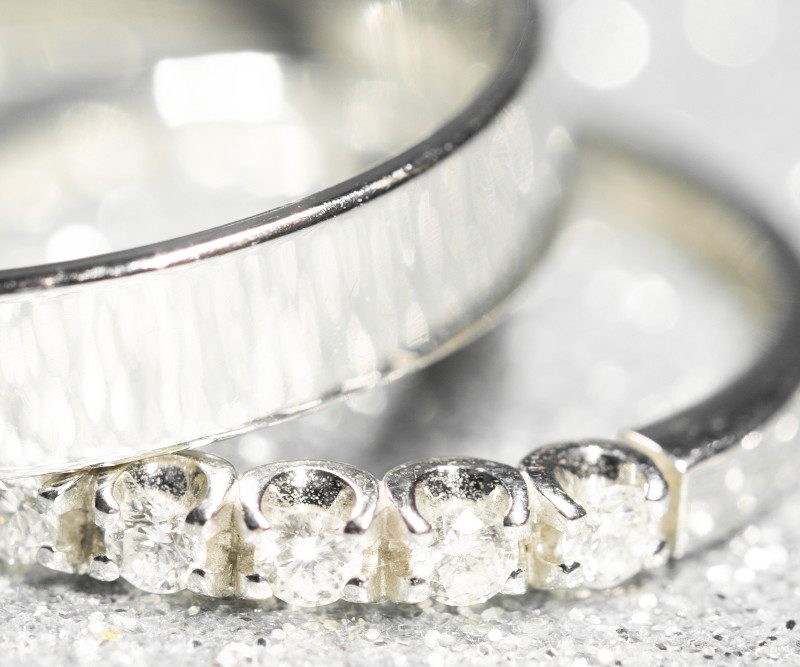 Two wedding rings on a glitter background