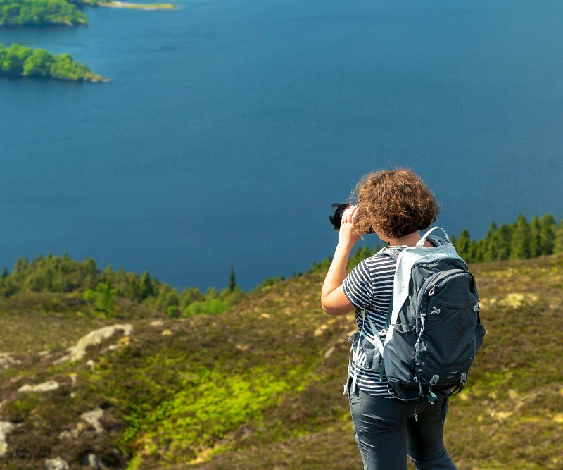 Woman taking photos in Scotland