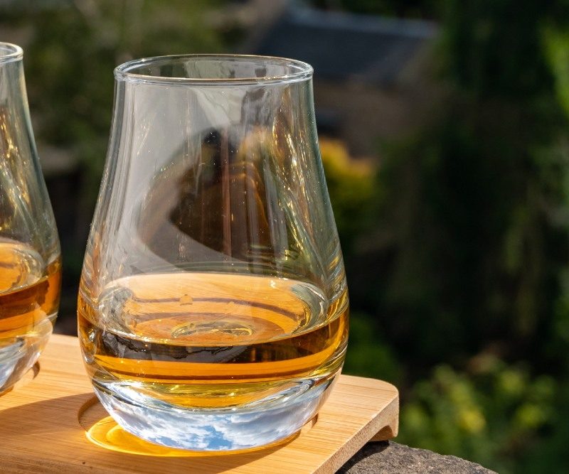 Three glasses of whisky on a window sill