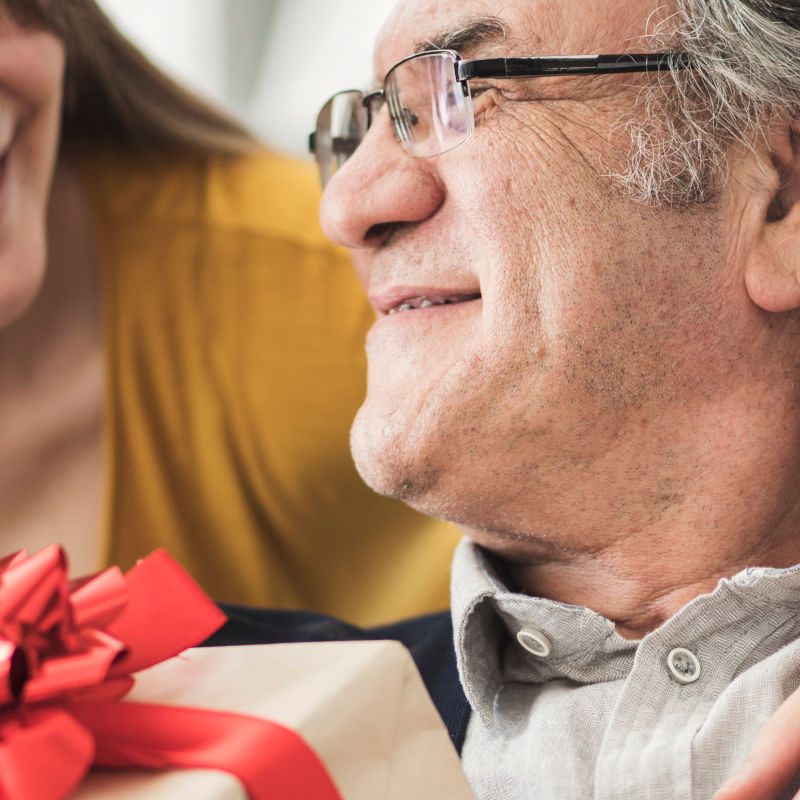 Woman giving her Dad a gift on Father's Day
